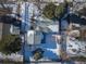 Aerial view of a residential home with snow-covered roof, trees and yard at 1120 Hartford Dr, Boulder, CO 80305