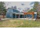 Spacious backyard with a patio featuring a pergola, seating area, and a two-story blue house at 1120 Hartford Dr, Boulder, CO 80305