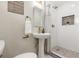 Bright bathroom featuring a pedestal sink, shower, and decorative tile details at 1120 Hartford Dr, Boulder, CO 80305