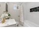 Cozy bathroom featuring a modern sink, neutral tile, and bathtub with black marble inset at 1120 Hartford Dr, Boulder, CO 80305