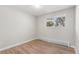 A clean and bright bedroom with light wood floors and large windows at 1120 Hartford Dr, Boulder, CO 80305