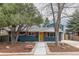 Charming exterior of a two-story home featuring blue paint, a well-manicured lawn, and tasteful landscaping at 1120 Hartford Dr, Boulder, CO 80305