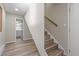 Hallway featuring wood floors, stairs, and an open powder room with natural light at 1120 Hartford Dr, Boulder, CO 80305