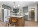 Gorgeous kitchen with an island and stools, stainless steel appliances, grey cabinets, and hardwood floors at 1120 Hartford Dr, Boulder, CO 80305