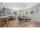 Open-concept living room with wood floors, bar seating at the kitchen island, and modern furniture at 1120 Hartford Dr, Boulder, CO 80305