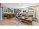 Open-concept living room with wood floors, bar seating at the kitchen island, and modern furniture at 1120 Hartford Dr, Boulder, CO 80305