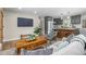 Living room featuring an open floor plan, a TV, wood floors, and a view of the kitchen at 1120 Hartford Dr, Boulder, CO 80305