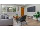 Comfortable living room featuring modern decor, wood floors, a large window, and a wood accent door at 1120 Hartford Dr, Boulder, CO 80305