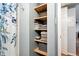 Organized bathroom closet with open shelving, providing ample storage for linens and toiletries at 3663 S Sheridan Blvd # O15, Denver, CO 80235