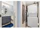 Efficient bathroom laundry area with stacked washer and dryer, optimizing space and convenience at 3663 S Sheridan Blvd # O15, Denver, CO 80235