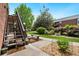 Inviting building exterior with landscaped grounds, wooden stairs, and a welcoming walkway at 3663 S Sheridan Blvd # O15, Denver, CO 80235