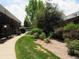 Attractive building exterior with green space and walking paths creating a serene outdoor environment at 3663 S Sheridan Blvd # O15, Denver, CO 80235