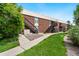 Well-maintained building exterior with lush green lawn and convenient walkway access for residents at 3663 S Sheridan Blvd # O15, Denver, CO 80235