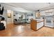 Open-concept living and kitchen area featuring hardwood floors, a spacious layout and natural light at 3663 S Sheridan Blvd # O15, Denver, CO 80235