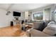 Relaxing living room featuring a large sofa, mounted TV, and modern decor at 3663 S Sheridan Blvd # O15, Denver, CO 80235