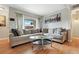 Comfortable living room featuring a large sectional sofa, glass coffee table, and bright natural light at 3663 S Sheridan Blvd # O15, Denver, CO 80235
