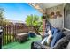 Cozy outdoor patio with comfortable wicker furniture and charming decor under a sunny sky at 3663 S Sheridan Blvd # O15, Denver, CO 80235