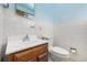 Bathroom featuring patterned tiles and a wood vanity at 1661 E 86Th Pl, Denver, CO 80229