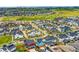 Community aerial view showcasing colorful houses, landscaping, and green spaces in the distance at 9769 E 62Nd Dr, Denver, CO 80238