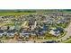 Expansive aerial view of a residential neighborhood with green spaces, community pool, and varied home styles at 9769 E 62Nd Dr, Denver, CO 80238