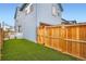 Fenced backyard featuring new sod, creating a private and inviting outdoor space at 9769 E 62Nd Dr, Denver, CO 80238