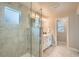 A bright bathroom with a glass shower stall featuring marble tile and stylish fixtures at 9769 E 62Nd Dr, Denver, CO 80238