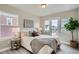 A beautifully furnished bedroom with a king bed and large windows offering outdoor views at 9769 E 62Nd Dr, Denver, CO 80238