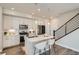 Well-lit kitchen with stainless appliances, center island with seating, and sleek, modern finishes at 9769 E 62Nd Dr, Denver, CO 80238