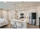 Modern kitchen features an island with seating, stainless steel appliances, and a bright, open layout at 9769 E 62Nd Dr, Denver, CO 80238