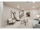 A modern living room with seating, stylish decor, and a staircase in view at 9769 E 62Nd Dr, Denver, CO 80238
