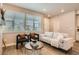 Inviting living room with neutral tones, comfortable seating, large windows, and modern decor at 9769 E 62Nd Dr, Denver, CO 80238