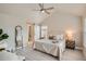 Serene bedroom features vaulted ceiling, modern barn door to ensuite, and neutral decor for relaxation at 9769 E 62Nd Dr, Denver, CO 80238