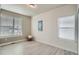A minimalist room with neutral walls, two windows, and light wood flooring at 9769 E 62Nd Dr, Denver, CO 80238