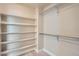A large walk-in closet with white shelving and metal clothing rods for ample storage at 9769 E 62Nd Dr, Denver, CO 80238