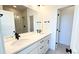 Double vanity bathroom with modern faucets and a large mirror, adjacent to a glass door shower at 2668 W 68Th Ave, Denver, CO 80221