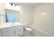 Clean bathroom featuring a vanity, toilet, and a shower-tub combo with white tiles at 2668 W 68Th Ave, Denver, CO 80221