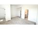 Bright, carpeted bedroom with neutral tones and a double doorway leading to a closet and bathroom at 2668 W 68Th Ave, Denver, CO 80221