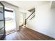 Bright entryway with hardwood floors, white walls, and staircase leading to the upper level at 2668 W 68Th Ave, Denver, CO 80221