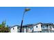 Modern home exterior showcasing gray siding, black trim, and a street lamp against a blue sky at 2668 W 68Th Ave, Denver, CO 80221