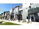 Modern townhome exterior featuring a balcony, stylish siding, and well-maintained landscaping at 2668 W 68Th Ave, Denver, CO 80221