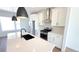 Modern kitchen features stainless steel appliances, an island with a black sink and white cabinetry at 2668 W 68Th Ave, Denver, CO 80221