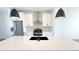 Modern kitchen featuring stainless steel appliances, white cabinets, and island with black sink at 2668 W 68Th Ave, Denver, CO 80221