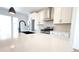 Kitchen featuring stainless steel appliances, white cabinets, and a center island with a black sink at 2668 W 68Th Ave, Denver, CO 80221
