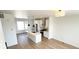 Open-concept living space with a modern kitchen, hardwood floors, and ample natural light at 2668 W 68Th Ave, Denver, CO 80221