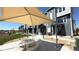 Enjoy the outdoors on this cozy patio with a checkerboard table and shade umbrella near the modern townhomes at 2668 W 68Th Ave, Denver, CO 80221