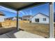 Expansive backyard showcasing a wood fence and a home exterior under a clear, blue sky at 771 Sunflower Dr, Brighton, CO 80601