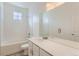 Well-lit bathroom featuring a tiled shower-tub, modern vanity, and a large mirror at 771 Sunflower Dr, Brighton, CO 80601