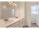 Bathroom features double sinks, a large mirror, and modern lighting at 771 Sunflower Dr, Brighton, CO 80601