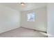 Clean, bright bedroom with neutral carpet, white walls, and a single window with a pleasant view at 771 Sunflower Dr, Brighton, CO 80601