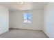 Simple yet spacious bedroom with neutral carpet, white walls, and a bright, sunny window at 771 Sunflower Dr, Brighton, CO 80601